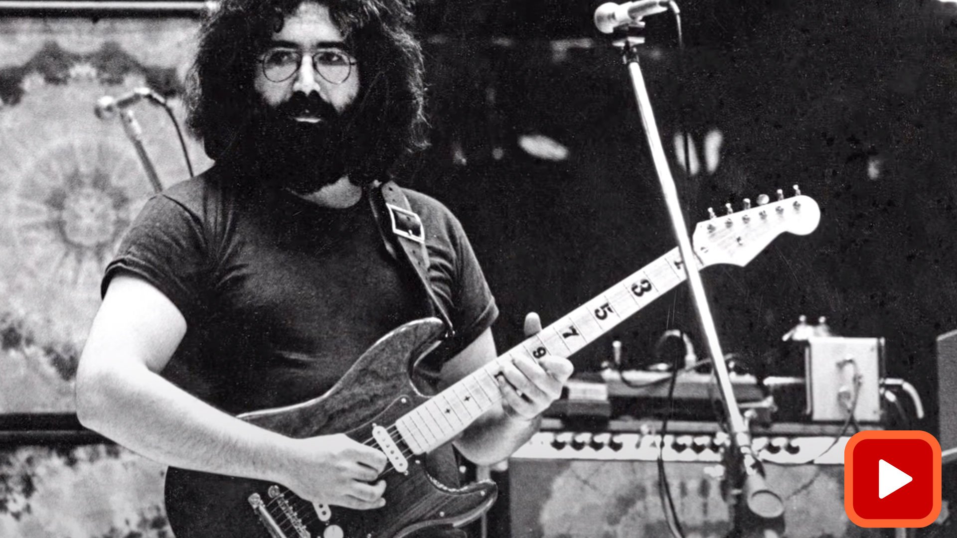Jerry Garcia playing guitar with wood pickguard