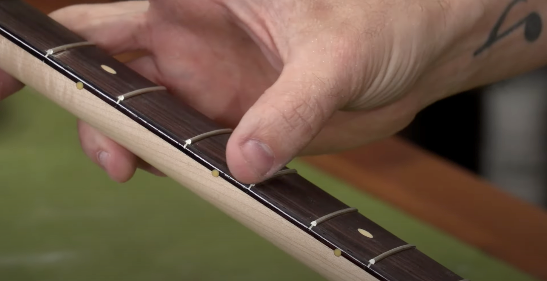 Removing tape from the fretboard
