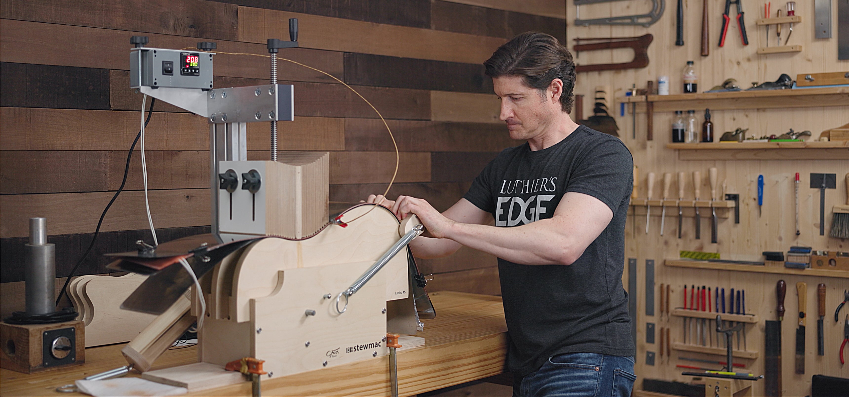 Luthier Tom Bills in his shop using the StewMac Acoustic Guitar Side Bender.
