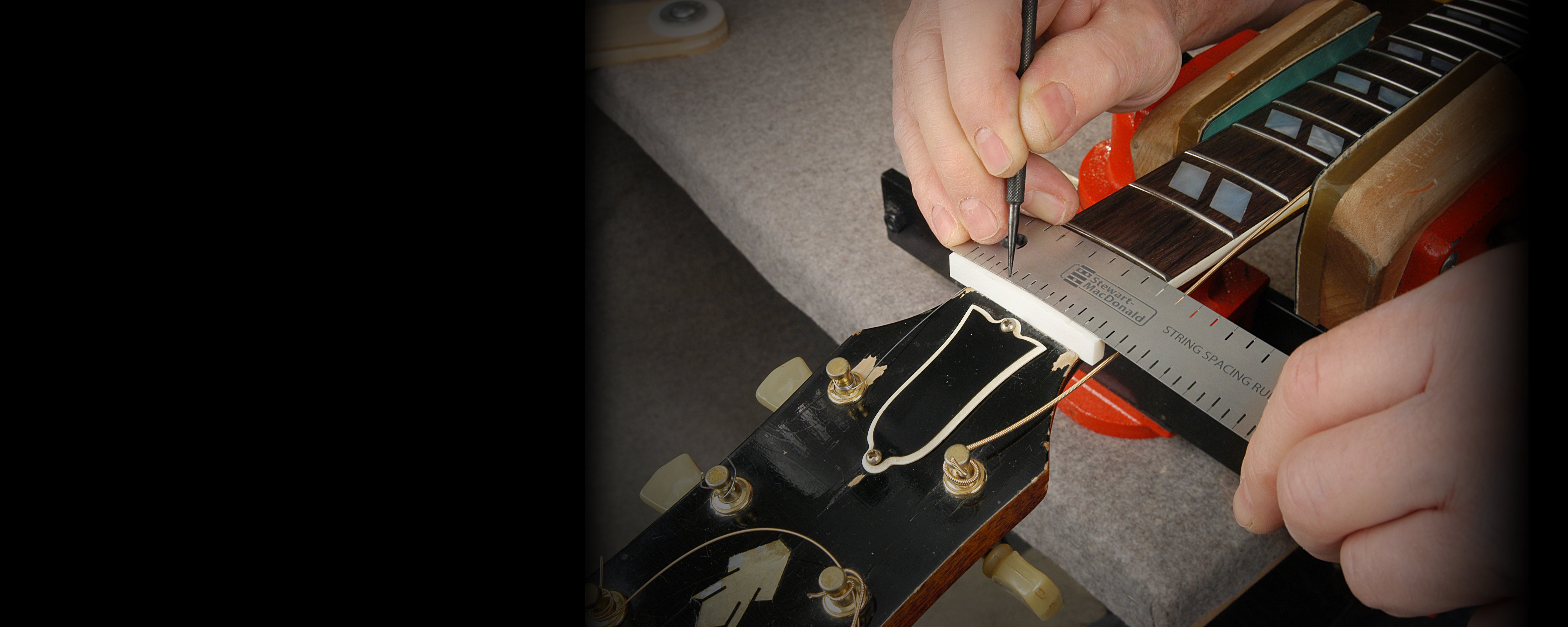 Measuring the slots for a new guitar nut with the String Spacing Rule.