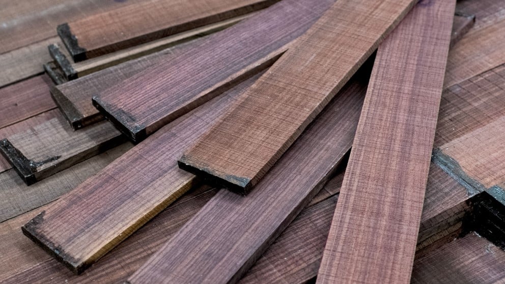 Multiple Indian Rosewood fingerobards spread out on a table.