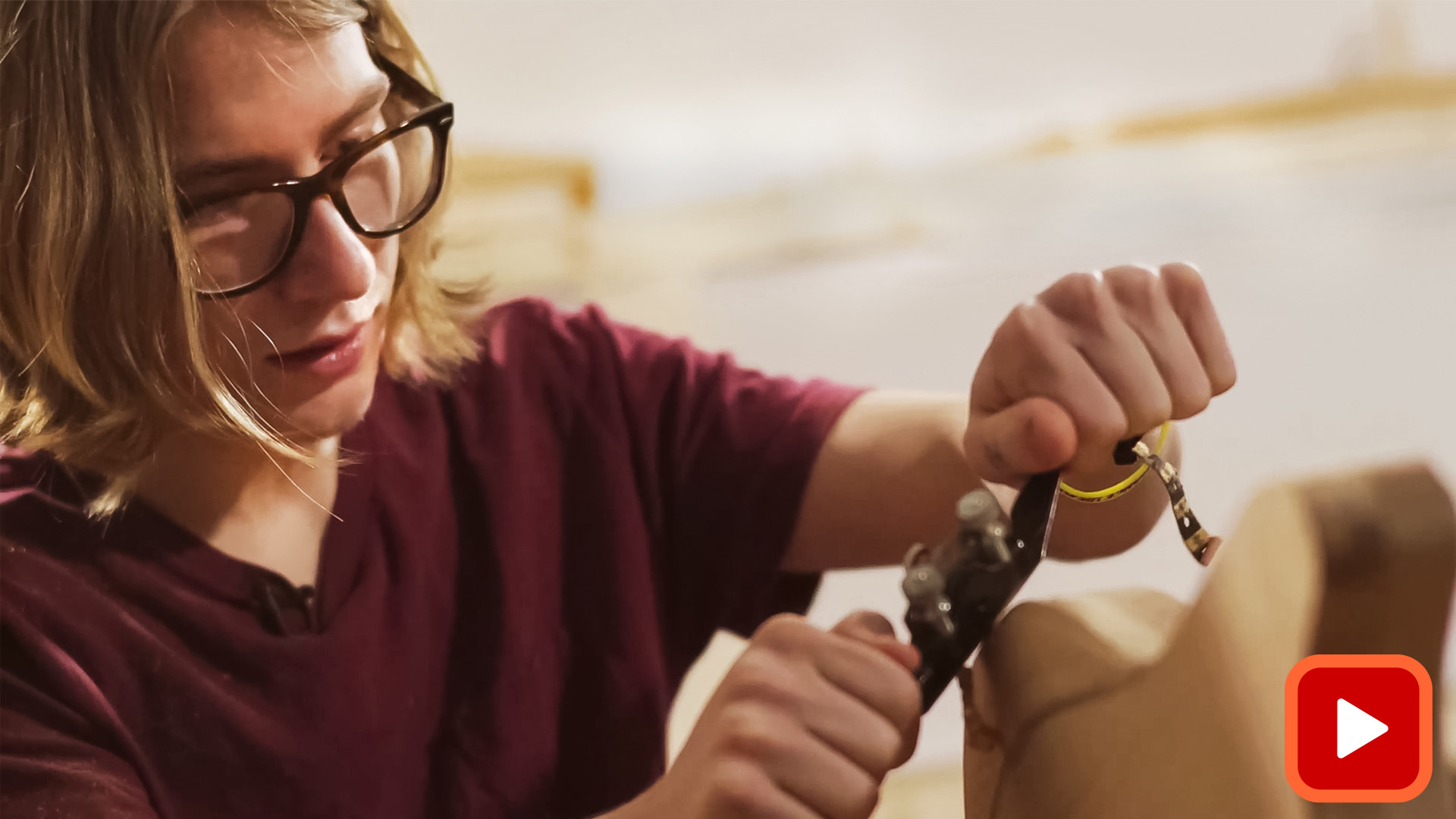 Person shaping an electric guitar side with a plane