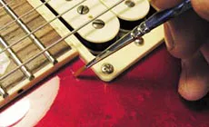 Lacquer drop fill: hiding a scratch on a customer's Les Paul - StewMac