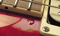 Lacquer drop fill: hiding a scratch on a customer's Les Paul - StewMac