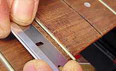Scraping a fingerboard