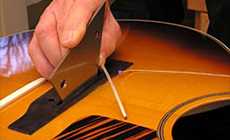 Checking the saddle slot with a Fret Rocker