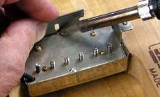 Photo: desoldering the humbucker cover