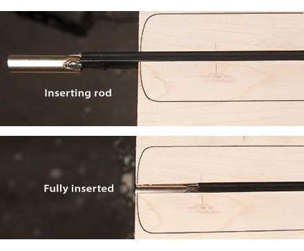 Sliding the truss rod into the end of the channel. 