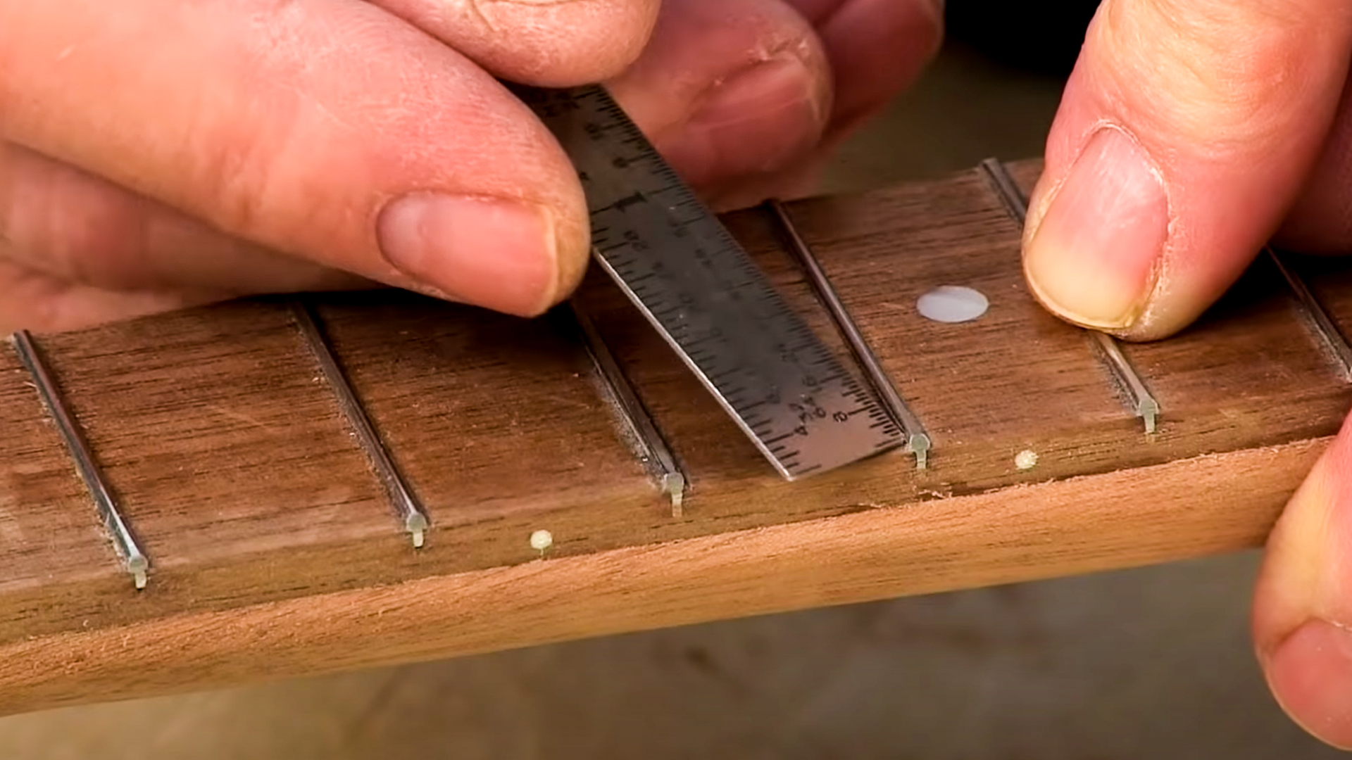 Ruler removing burr from sides of frets